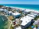 Scenic aerial view of coastal condominiums with pools and docks, perfectly situated near a pristine beach at 901 Gulf S Dr # 14, Bradenton Beach, FL 34217