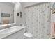 Cozy bathroom with shower curtain, toilet, and vanity with white countertops at 901 Gulf S Dr # 14, Bradenton Beach, FL 34217