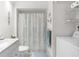 Bathroom with laundry closet and a shower with flower design shower curtain at 901 Gulf S Dr # 14, Bradenton Beach, FL 34217