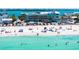 A gorgeous beach view near the property featuring white sand, clear turquoise water, and relaxing beachgoers at 901 Gulf S Dr # 14, Bradenton Beach, FL 34217
