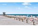 A lovely beach with a lifeguard tower and people enjoying the sunshine and clear ocean waters at 901 Gulf S Dr # 14, Bradenton Beach, FL 34217