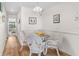 Charming dining area with a glass-top table and four wicker chairs at 901 Gulf S Dr # 14, Bradenton Beach, FL 34217