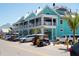 Two-story commercial building with shops and restaurants and parked cars at 901 Gulf S Dr # 14, Bradenton Beach, FL 34217
