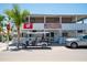 Charming bar and grill with outdoor seating, a golf cart, and visible branding along a sunny street at 901 Gulf S Dr # 14, Bradenton Beach, FL 34217