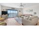 Cozy living room featuring beach decor and an open layout with a scenic view from the large sliding glass doors at 901 Gulf S Dr # 14, Bradenton Beach, FL 34217