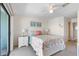 Bright main bedroom with a balcony overlooking palm trees and the community pool at 901 Gulf S Dr # 14, Bradenton Beach, FL 34217