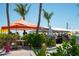 Outdoor dining area with people seated at tables and a view of the water at 901 Gulf S Dr # 14, Bradenton Beach, FL 34217