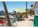 Relaxing outdoor seating area with colorful chairs, umbrellas, and tables near the dock and waterfront views at 901 Gulf S Dr # 14, Bradenton Beach, FL 34217