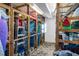 Spacious storage room with wooden shelving units filled with beach gear and household items at 901 Gulf S Dr # 14, Bradenton Beach, FL 34217