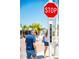People crossing the street at crosswalk with view of a stop sign and Bridge Street sign at 901 Gulf S Dr # 14, Bradenton Beach, FL 34217