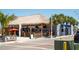 Outdoor tiki bar with thatched roof, outdoor seating, and palm trees at 901 Gulf S Dr # 14, Bradenton Beach, FL 34217