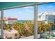 Enjoy this lovely view of the ocean, palm trees, and nearby properties from the comfort of your home at 901 Gulf S Dr # 14, Bradenton Beach, FL 34217