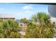 Tropical view of nearby buildings, palm trees, beach, and blue ocean at 901 Gulf S Dr # 14, Bradenton Beach, FL 34217
