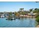 Picturesque waterfront view showcasing docks, boats, and outdoor dining near charming coastal buildings and palm trees at 901 Gulf S Dr # 14, Bradenton Beach, FL 34217