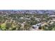 Scenic aerial view of a neighborhood featuring modern homes surrounded by lush trees, with the cityscape in the background at 941 N Osprey Ave, Sarasota, FL 34236
