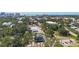 Stunning aerial view of a neighborhood with modern homes, lush trees, and waterfront scenery at 941 N Osprey Ave, Sarasota, FL 34236