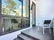 Inviting tiled balcony with modern outdoor furniture and large windows offering natural light at 941 N Osprey Ave, Sarasota, FL 34236