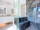 Luxurious marble shower with rainfall showerhead plus modern double sink vanity at 941 N Osprey Ave, Sarasota, FL 34236