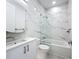 Bathroom featuring a shower over tub, marble walls, and a modern sink at 941 N Osprey Ave, Sarasota, FL 34236