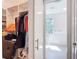 Walk-in closet with built-in shelving and hanging space leading to bathroom at 941 N Osprey Ave, Sarasota, FL 34236