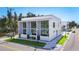 Contemporary home with large windows, a clean white exterior, and well-maintained landscaping at 941 N Osprey Ave, Sarasota, FL 34236