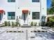 Charming townhouse with red awnings, well-maintained landscaping, and a paved parking area at 941 N Osprey Ave, Sarasota, FL 34236