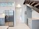 Stylish kitchen with stainless steel appliances, sleek cabinetry, and an adjacent staircase, maximizing space at 941 N Osprey Ave, Sarasota, FL 34236