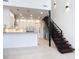 Modern kitchen seamlessly connecting to the living area with sleek appliances and a stylish staircase at 941 N Osprey Ave, Sarasota, FL 34236