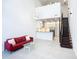 Open-concept living area with modern decor, staircase, and high ceilings, connecting kitchen and living spaces at 941 N Osprey Ave, Sarasota, FL 34236