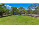A green recreation area features mature trees, benches, picnic tables, and a basketball court for neighborhood enjoyment at 941 N Osprey Ave, Sarasota, FL 34236