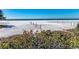 Picturesque view of Siesta Beach with white sand, volleyball nets, and clear blue water, perfect for leisure and recreation at 9620 Club South Cir # 5208, Sarasota, FL 34238