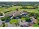 Stunning aerial view of the community clubhouse with lush landscaping and a meticulously maintained golf course at 9620 Club South Cir # 5208, Sarasota, FL 34238
