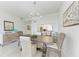 Inviting dining room features stylish chandelier, wood table, and wicker chairs, perfect for entertaining guests at 9620 Club South Cir # 5208, Sarasota, FL 34238