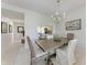 Well-lit dining room with a rustic wood table, elegant chandelier, and comfortable seating for Gathering meals at 9620 Club South Cir # 5208, Sarasota, FL 34238