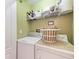Functional laundry room with a stacked washer and dryer, complemented by overhead shelving for optimal storage at 9620 Club South Cir # 5208, Sarasota, FL 34238