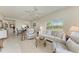 Bright living room with neutral tones, comfortable seating, and a view into the adjacent dining area at 9620 Club South Cir # 5208, Sarasota, FL 34238