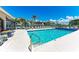 Community pool with lounge chairs, safety fence and shade umbrellas at 9620 Club South Cir # 5208, Sarasota, FL 34238