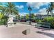 Charming street view with the Columbia Restaurant, lush greenery, and clear blue skies at 9620 Club South Cir # 5208, Sarasota, FL 34238