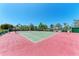 Community tennis court surrounded by trees and lush landscaping at 9620 Club South Cir # 5208, Sarasota, FL 34238