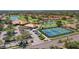 Aerial view of a golf community featuring a clubhouse, tennis courts and beautiful landscaping at 4812 Sand Trap E Cir, Bradenton, FL 34203