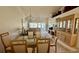 Spacious dining room featuring a large glass table, a ceiling fan and a built-in china cabinet at 4812 Sand Trap E Cir, Bradenton, FL 34203
