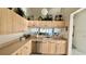 Modern kitchen with stainless steel appliances, wooden cabinets, and lots of plants for a fresh touch at 4812 Sand Trap E Cir, Bradenton, FL 34203