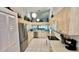 Well-lit kitchen featuring stainless steel appliances, wooden cabinets, and an open layout at 4812 Sand Trap E Cir, Bradenton, FL 34203