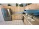 Bright kitchen featuring stainless steel appliances, light wood cabinets, and ample counter space at 4812 Sand Trap E Cir, Bradenton, FL 34203