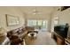 Comfortable living room with a ceiling fan and sliding doors to the outside at 4812 Sand Trap E Cir, Bradenton, FL 34203
