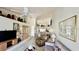 Open-concept living room featuring high ceilings, a ceiling fan, and a comfortable seating area at 4812 Sand Trap E Cir, Bradenton, FL 34203