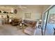 Bright living room with comfortable seating and a view of the backyard through sliding glass doors at 4812 Sand Trap E Cir, Bradenton, FL 34203