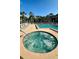 Community pool and hot tub surrounded by lounge chairs and a well-maintained deck at 4812 Sand Trap E Cir, Bradenton, FL 34203