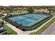 Aerial view of well-maintained tennis courts within a beautiful golf community with lake views at 4812 Sand Trap E Cir, Bradenton, FL 34203
