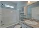 Bright bathroom with a shower-tub combo, vanity sink with stylish countertop, and a matching medicine cabinet at 104 1St Ave, Venice, FL 34285